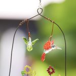 Two Glass Hummingbirds Over Glass Garden